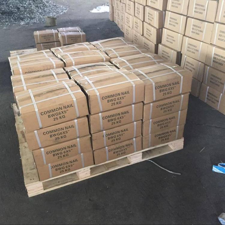  Large 25kg cartons of common nails stacked neatly on pallets in a Chinese export warehouse.