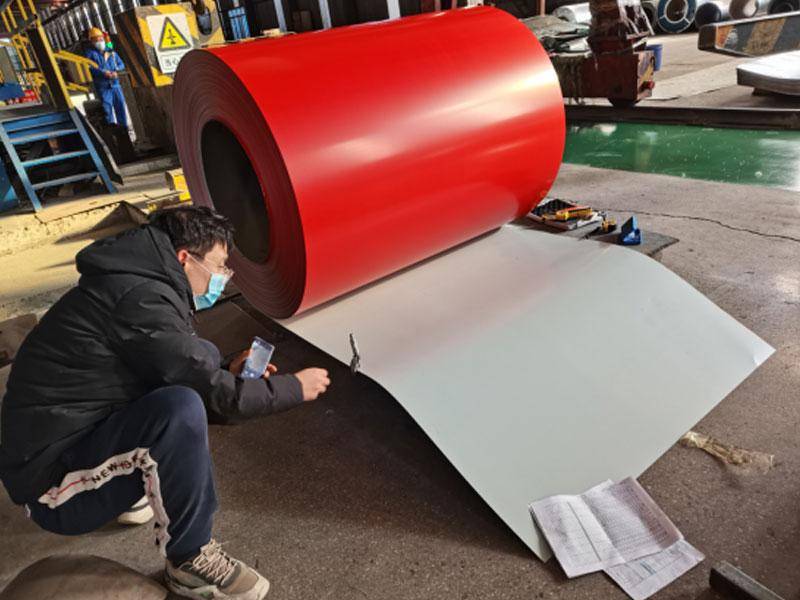 Factory worker at Chinese Camasteel partner mill inspecting PPGL coil surface quality