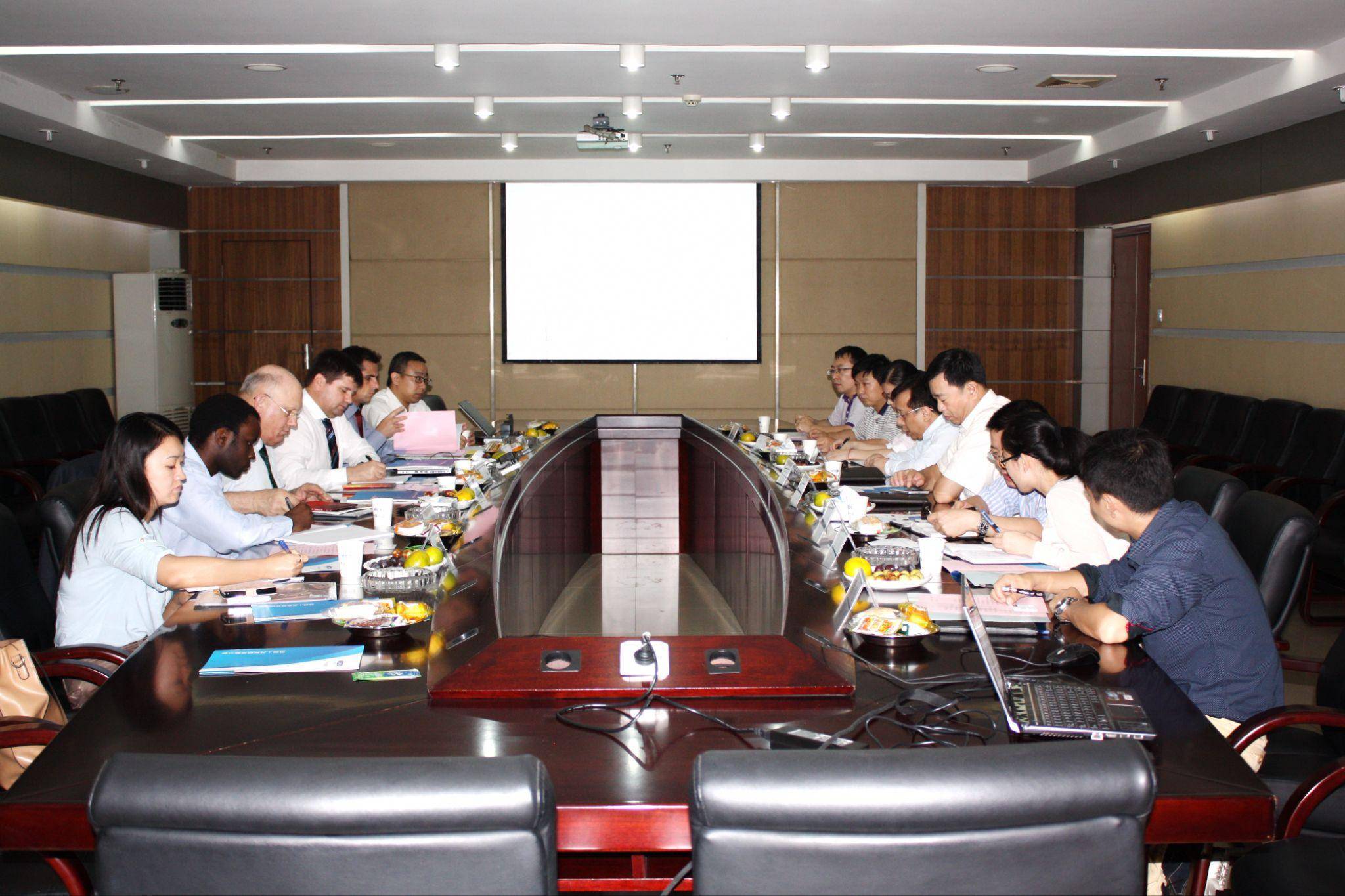 Diverse international team in formal business meeting discussing EU steel standards