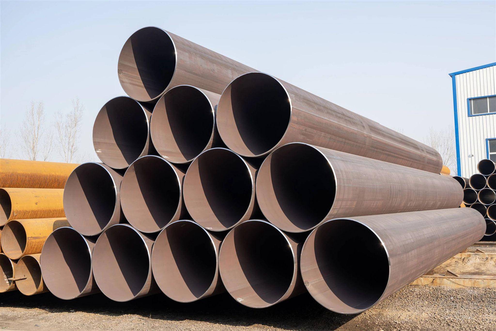 Stacked large seamless steel pipes ready for industrial and construction use