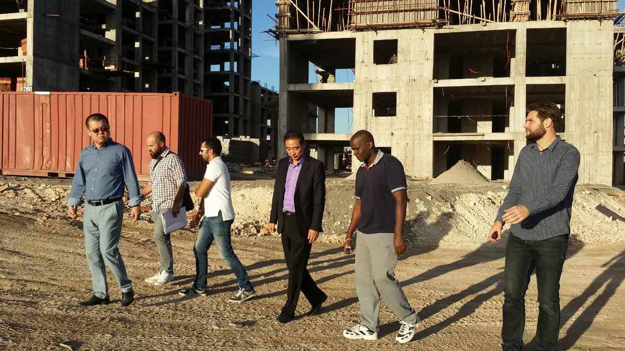 Group of engineers and project managers conducting site inspection at a large construction project in South Africa