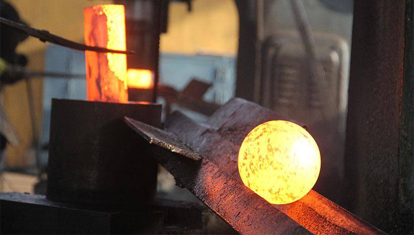 Close up of Heated forged steel grinding balls at an industrial site.
