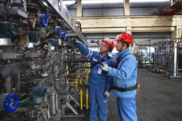  Diverse team of engineers, including Asian Chinese faces, reviewing plans in a modern steel plant with an Electric Arc Furnace in the background, symbolizing sustainable steelmaking.